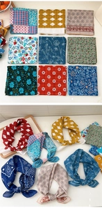 Detail of assorted cotton linen square scarves featuring diverse floral and ethnic patterns
