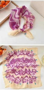 Detail of tropical palm tree and purple wave print on lightweight cotton linen scarf