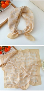 Detail of yellow plaid cotton linen scarf with fine hemmed edges and soft texture