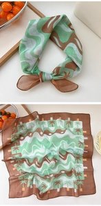 Detail view of cotton linen square scarf with palm tree print and brown border