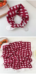 Detail of red and white diamond pattern cotton silk scarf on a minimalist table