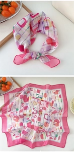 Detailed view of polka dot square scarf with geometric print and vibrant pink borders