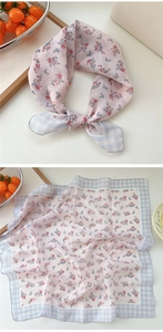 Detailed view of floral cotton linen scarf showing folded knot and flat pattern layout
