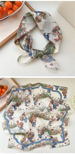 Detail of cotton linen scarf featuring vintage rabbit prints and a bright blue border