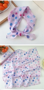 Detailed view of pink cotton linen scarf with artistic watercolor polka dots in knots