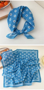 Detailed view of blue cotton linen neck scarf featuring white daisy prints and line borders