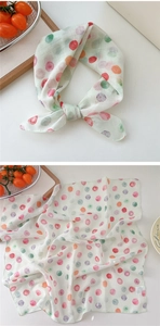 Close-up of colorful polka dot cotton linen scarf with fine stitched edges and soft texture