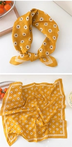 Detail of yellow cotton linen scarf with daisy print and white striped borders