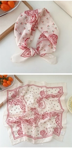 Detailed close-up of beige cotton linen scarf featuring red paisley and cherry patterns