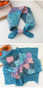 Flat lay of retro blue patchwork square scarf with paisley and houndstooth patterns