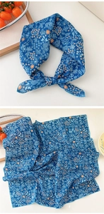 Detail of blue floral cotton scarf with delicate stitching and elegant patterns