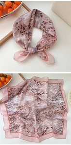 Detailed view of pink leopard print square cotton linen scarf with hand-rolled edges