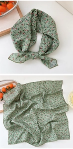 Detail of green floral cotton linen scarf with fine stitched edges and pastoral pattern