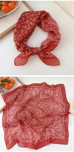 Detail of red paisley cotton linen square scarf with delicate white and yellow floral patterns