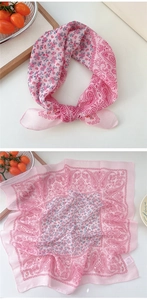 Close-up of pink paisley and floral cotton linen scarf with care label detail