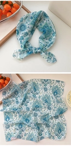 Close-up of teal paisley cotton linen scarf with fine stitched edges and floral pattern
