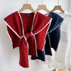 Women's knitted shawl wrap in red and navy colors with contrasting edge details