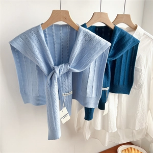 Knitted hollow out shrug shawl for women in light blue and navy blue over white shirt