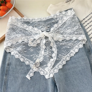Detail shot of white floral lace mini apron skirt featuring scalloped edges and tie-up strings