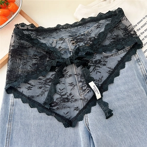Detail of black floral lace triangular scarf with chic bow and delicate crochet edges