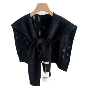 Knitted black shawl wrap with vertical hollow out pattern on wooden hanger