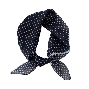 Navy blue polka dot cotton-linen square scarf tied in a stylish knot for women