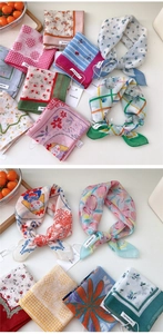 Detail view of cotton linen small scarves with floral, polka dot, and plaid patterns