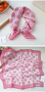 Detail view of pink and white gingham cotton scarf with polka dots for women