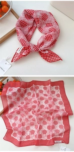 Detail of red and white polka dot cotton linen neckerchief with checked border edge