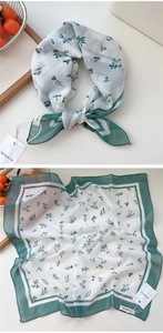 Detailed close-up of a floral cotton linen square scarf with berry print and green borders