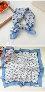 Detail of white and blue floral cotton linen square scarf with solid blue border