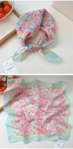 Detail view of lightweight cotton-linen blend square scarf with pastel peach floral print