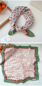 Detail of square cotton linen scarf with red floral print and dark green border