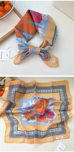 Detailed pattern of a cotton-linen scarf with orange flowers and vintage purple border
