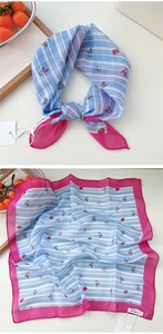 Detail of cotton linen scarf featuring blue white stripes and red bunny cherry prints
