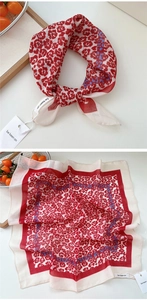 Detail of red floral cotton linen square scarf with white border and brand tag