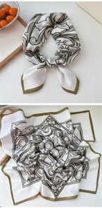 Détail d'un foulard carré en soie avec motifs baroques olive sur tissu blanc pur