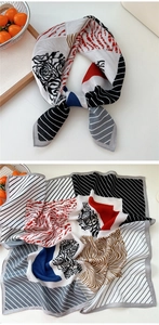 Détail d'un foulard en soie imprimé avec des rayures, zébrures et motifs géométriques