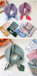 Detailed view of various polka dot and floral cotton linen square scarves with tags