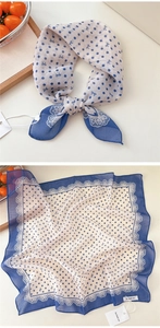 Detailed view of blue polka dot scarf with bow prints and delicate lace edge design