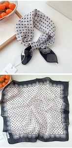 Close-up of polka dot scarf with bow patterns and delicate white lace edges