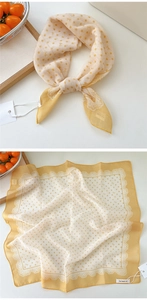 Detail of yellow polka dot square scarf with white lace trim and bow patterns