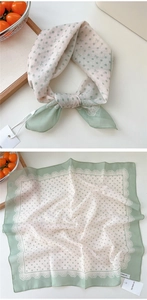 Detail of sage green polka dot cotton linen scarf with elegant lace trim and bow pattern
