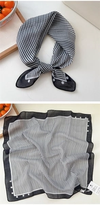 Close-up of black and white striped silk square scarf with polka dot border details
