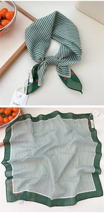 Detail view of green striped cotton silk scarf with red polka dots and dark green borders