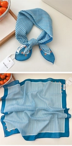 Detail of blue white striped square scarf with orange polka dots and brand tag