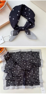 Detailed view of polka dot silk scarf featuring contrasting borders and a soft texture