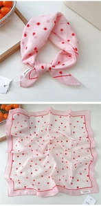 Close-up of pink polka dot square scarf tied in a bow with light breathable texture
