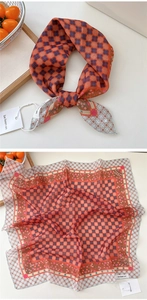 Detail view of retro polka dot silk scarf with floral prints and hemmed edges