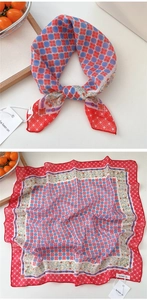 Detailed pattern of red and blue polka dot square scarf with floral borders